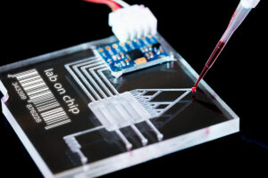 A lab on chip is device integrates several laboratory processes in one device, mostly LOC based on glass plate. The barcode on the plate is meaningless. It was made by me for this shot.